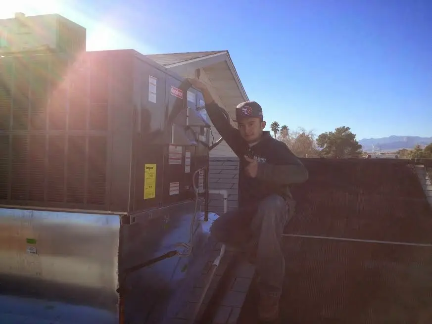 HVAC technician performing Heat Pump Repair on a rooftop unit in Southeast Arcadia